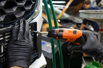 Auto mechanic repairing car. Selective focus.