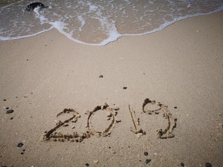 Happy New Year written on the beach