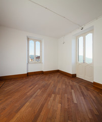 Obraz premium White empty room with two windows overlooking the Swiss hills
