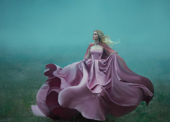  Fantasy woman blonde hair queen runs in fog summer green forest. Pink royal silk satin dress...