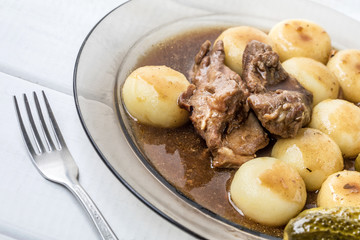 Stewed turkey meat served with silesian dumplings and sauce.