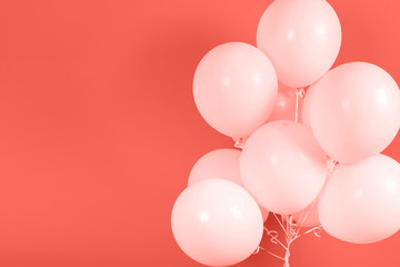 Living Coral background with bunch of flying balloons, copy space for text. Color of the year 2019. Christmas, birthday, valentine, wedding, holiday concept