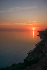 Amazing sunset over the sea and coastline.
