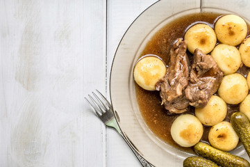 Stewed turkey meat served with silesian dumplings and sauce.