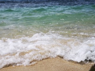 Beautiful wave breaks into the shore and created swash to the beach