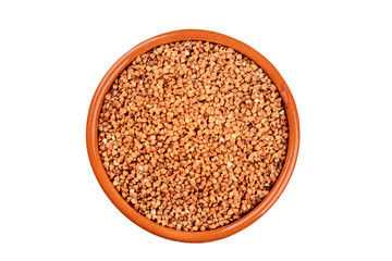 A photo of dry buckwheat in an earthenware bowl, shot from the top, isolated on a white background with a clipping path