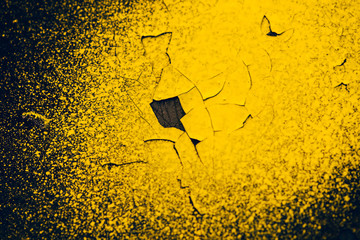 Rough dark black wall with yellow sprays of dye. Colorful background closeup. Dark black texture of concrete wall surface with yellow spots of paint. Painted backdrop. Exfoliated paint. Flaking stucco