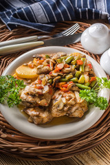 Fillet of chicken legs with stewed vegetables.