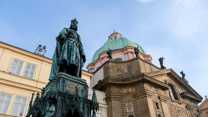 Fototapeta na wymiar Charles IV Statue next to Prague Charles Bridge. The monument of King Charles IV is one of the best preserved and most significant neo-Gothic statues in Central Europe.