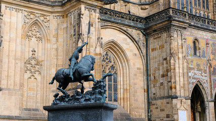 Obraz premium Statue of St. George next to st. Vitus Cathedral in Prauge Castle, The most significant Czech Gothic statues made of bronze. The statue shows St. George who is fighting with dragon. 