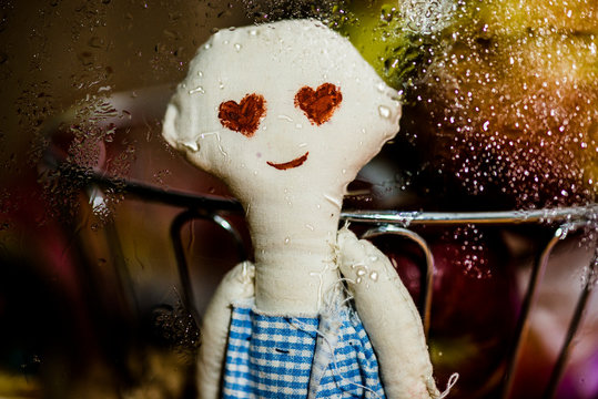 Doll in love outside the window