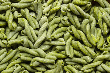 Uncooked spinach gemelli pasta.