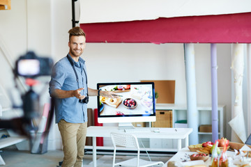 Portrait of handsome photographer leading online seminar on food photography, copy space