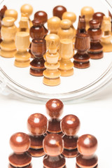 Chess pieces facing mirror. Business and motivational concepts. High resolution image.