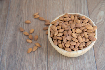Almond nut on wood background.