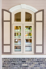 Fototapeta na wymiar Casement windows with arched frame on top. It is designed in vintage European styles.