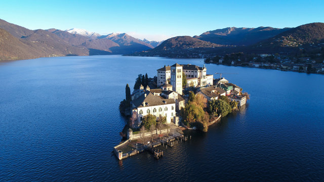Aerial view of Lake Orta (Piedmont, Italy) with the San Giulio island at dawn on a sunny winter day.