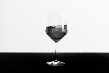 Black and white photo of red wine in motion in a glass