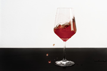 Red wine splashing out of a glass