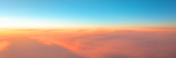 Panorama of the evening sky sunset gradient from warm to cold color.