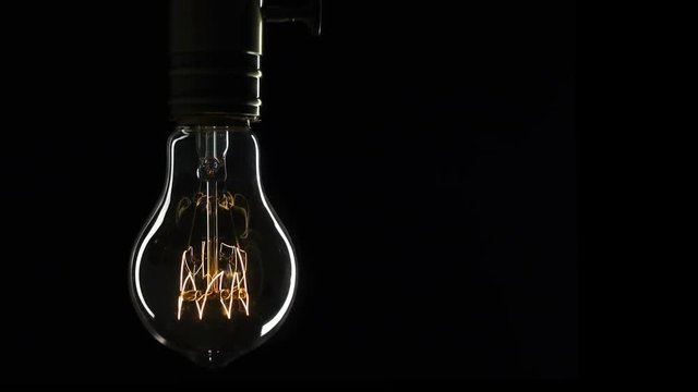 Edison's light bulb illuminates slowly from electric current