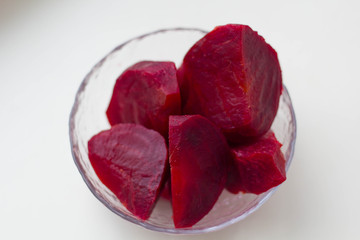 Boiled beets cut into pieces in a plate closeup