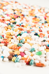 High number of pills on white background surface. High resolution image for pharmaceutical industry.