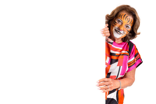 senior woman with tiger face-paint