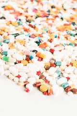 Fototapeta na wymiar High number of pills on white background surface. High resolution image for pharmaceutical industry.