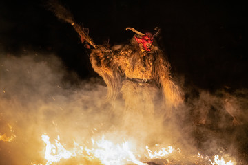 The Krampus masks in an exhibition in the night in Tarvisio, Italy