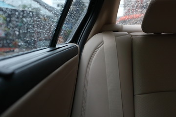 back seat inside vehicle car with rain drop on window
