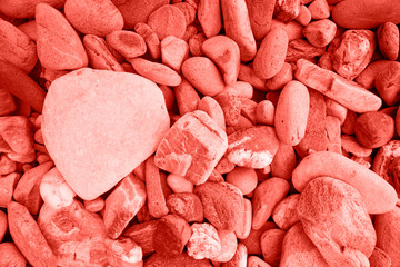 Living Coral color different sizes pebble stone. Stones background.