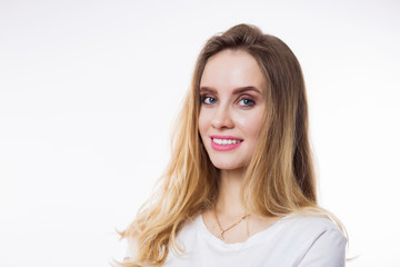 Fototapeta premium Closeup portrait of beautiful happy young woman with blonde hair and looking at camera on white background.