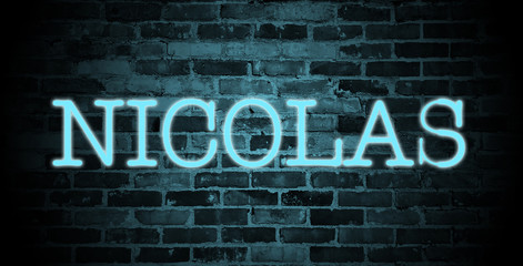 Obraz premium first name Nicolas in blue neon on brick wall