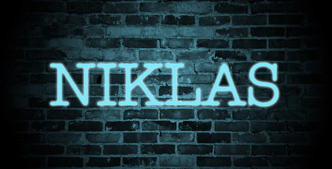 Obraz premium first name Niklas in blue neon on brick wall
