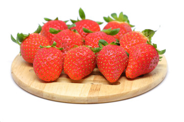 red strawberry on wooden plate
