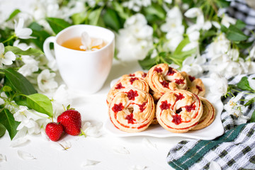Morning. Spring season. Mood. Blossom apple. Herbal tea and biscuits with strawberries.