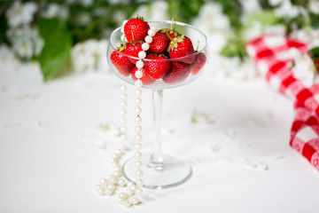 Morning. Spring season. Mood. Blossom apple. Ripe strawberries in a glass.