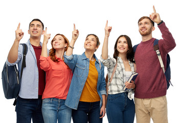 Obraz premium education, high school and people concept - group of smiling students pointing fingers up over white background