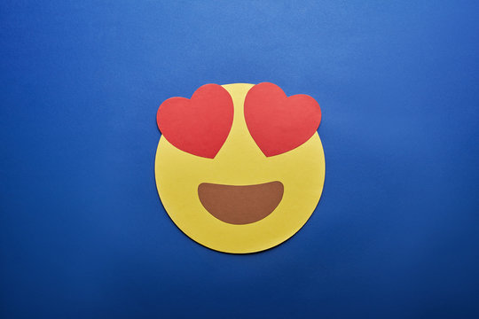 Top View Of In Love Emoji On Blue Background