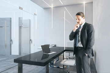Thoughtful caucasian businessman in office