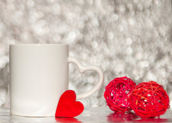 white mag on the blurred background with red heart. bokeh effect background