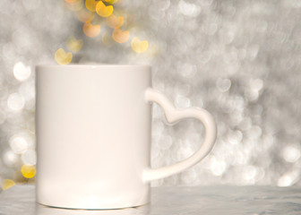 white mag on the blurred background with red heart. bokeh effect background