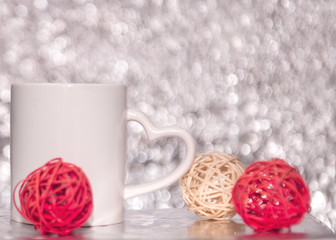 white mag on the blurred background with red heart. bokeh effect background