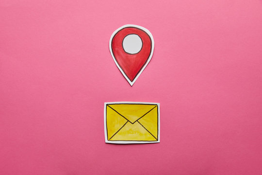 yellow mail sign with red geolocation on pink background
