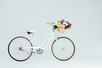 Fototapeta na wymiar bicycle with flower basket isolated on grey
