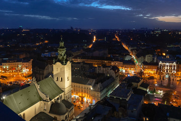 Naklejka premium Panoramic night sunset cityscape view on roofs and domes of Lviv, Ukraine