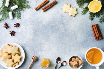 Fototapeta na wymiar Cup of tea and cookies, pine branches, cinnamon sticks, anise stars. Christmas, winter concept. Flat lay top view