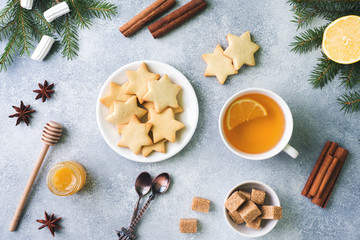 Cup of tea and cookies, pine branches, cinnamon sticks, anise stars. Christmas, winter concept. Flat lay top view