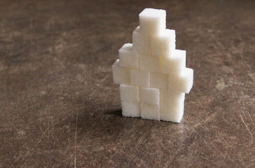 house of sugar cubes on a brown table